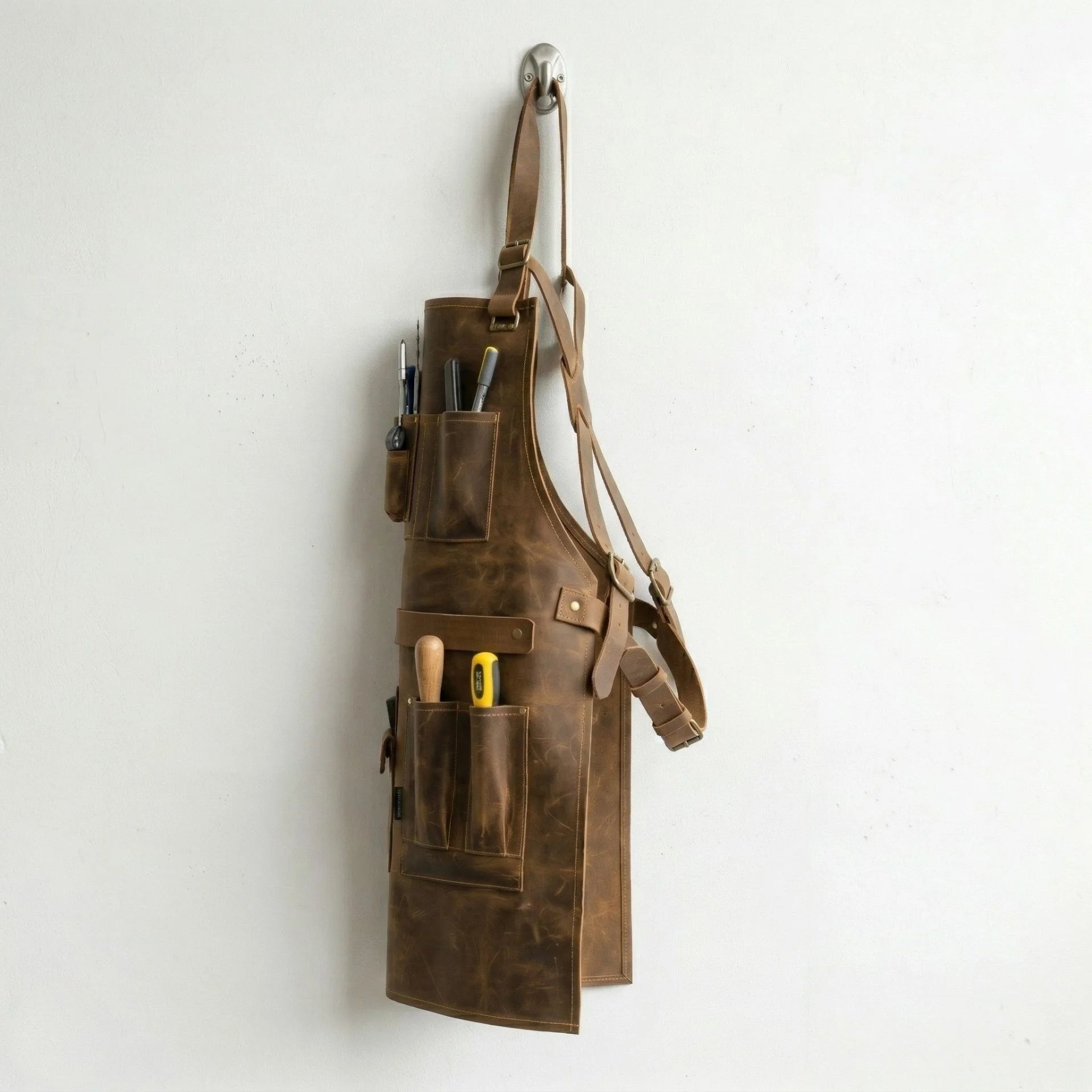 Opposite side view of leather work apron with pockets and straps