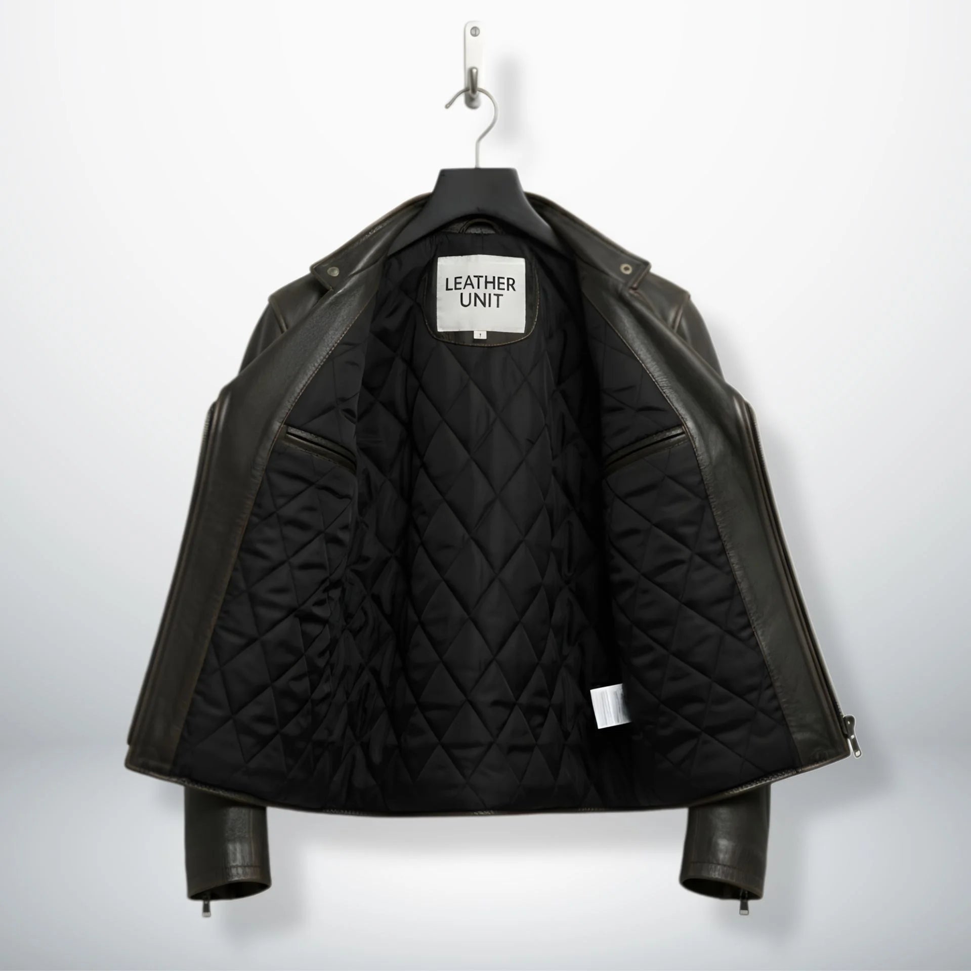 interior of men's leather biker jacket showing black quilted lining.