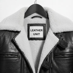 Close up of shearling collar and Leather Unit label on black Bane coat.