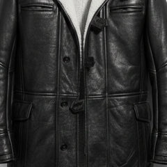 Close up of buttons, toggles and pockets on men's black Bane leather coat.