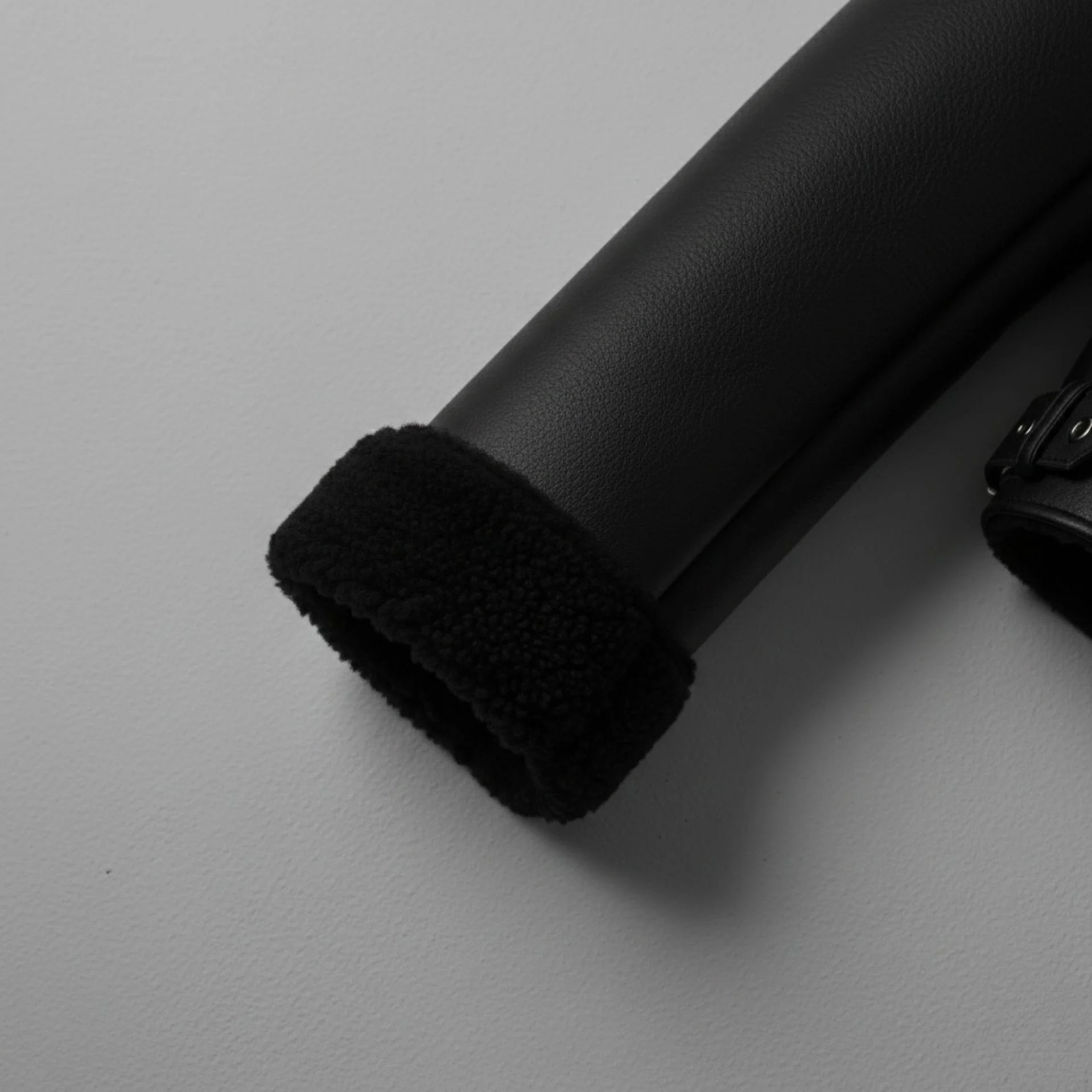 close up shearling cuff on mens black aviator bomber leather sleeve.