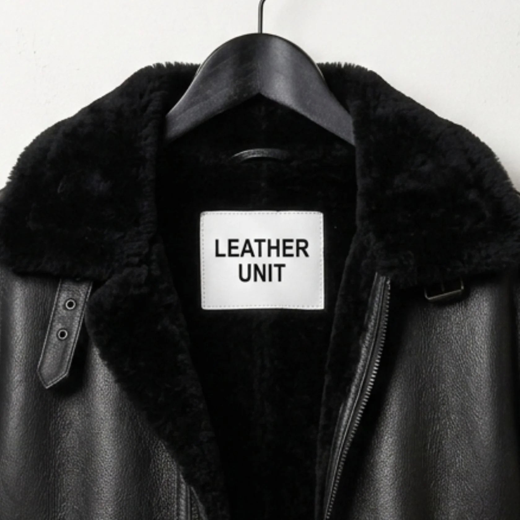 close up collar and buckle throat latch on mens black b3 shearling jacket.