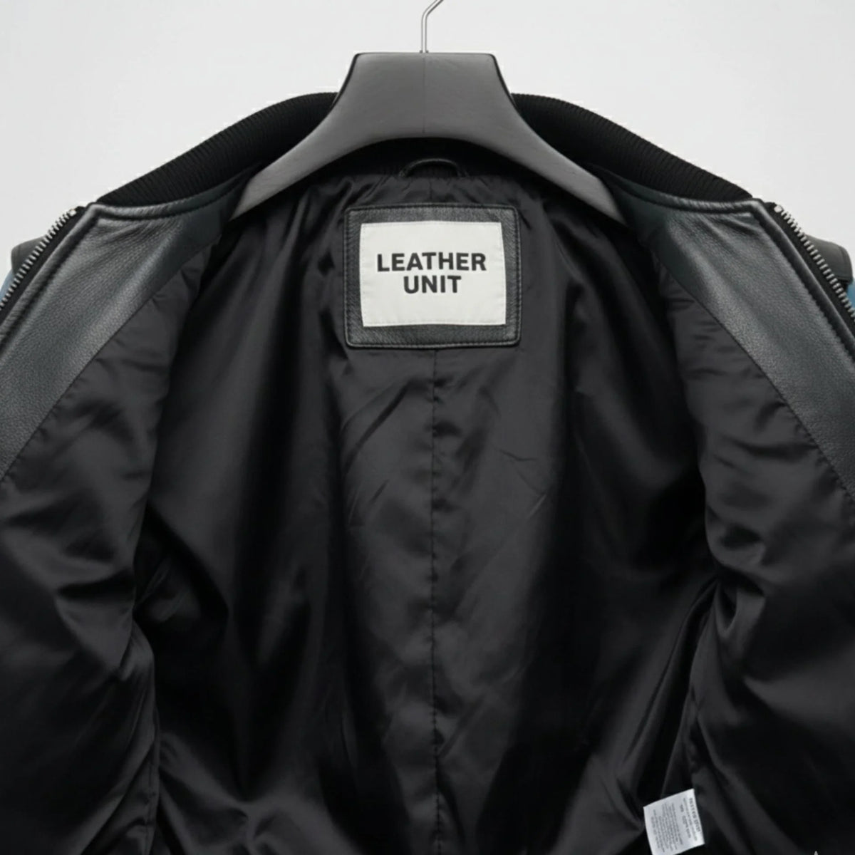 interior lining of mens black blue bomber leather jacket leather unit label.