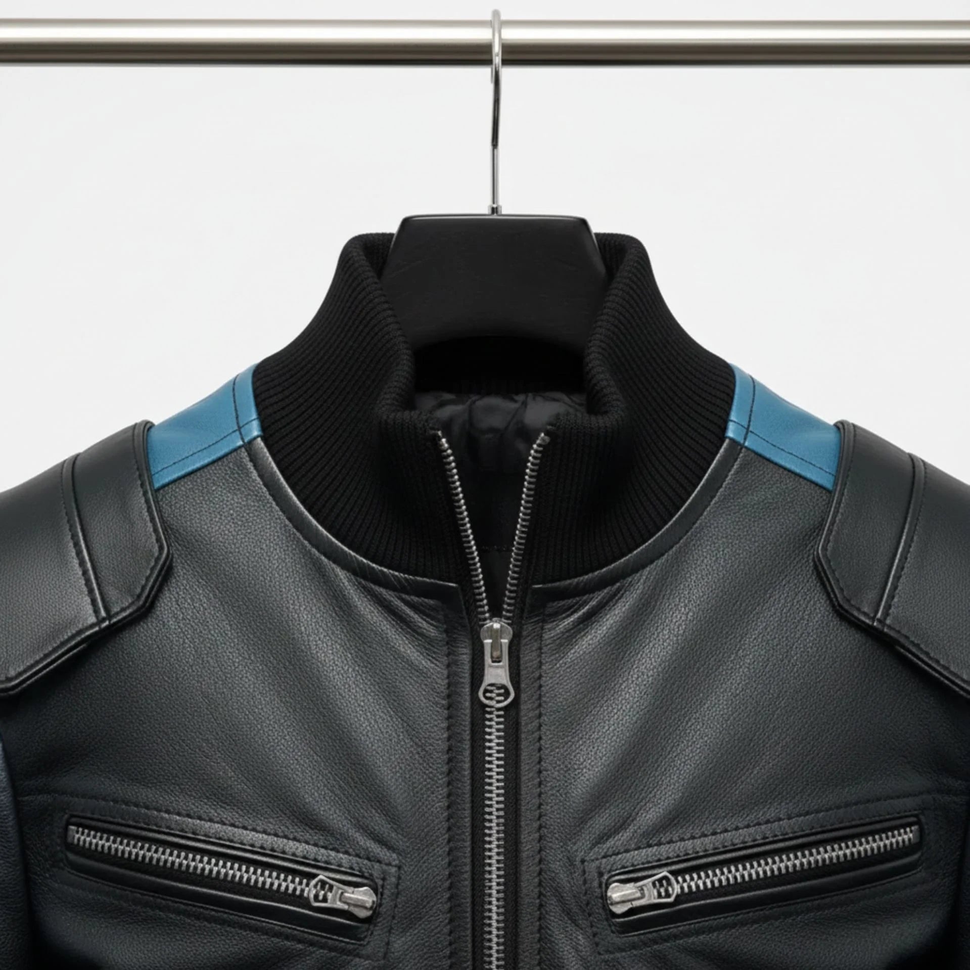 close up ribbed collar and front zipper on black leather bomber jacket.