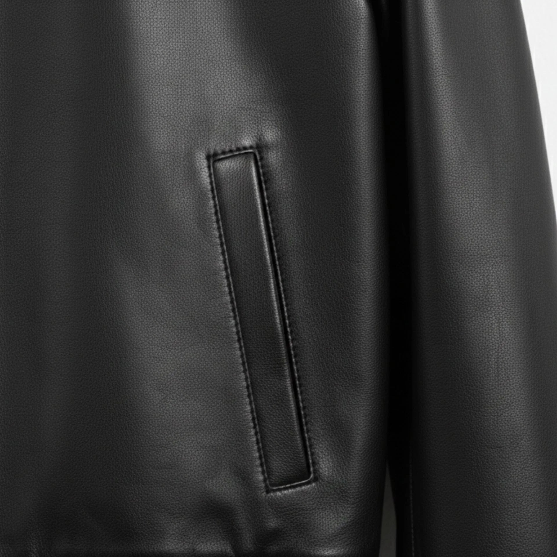 close up welt hand pocket on mens black genuine leather bomber jacket.