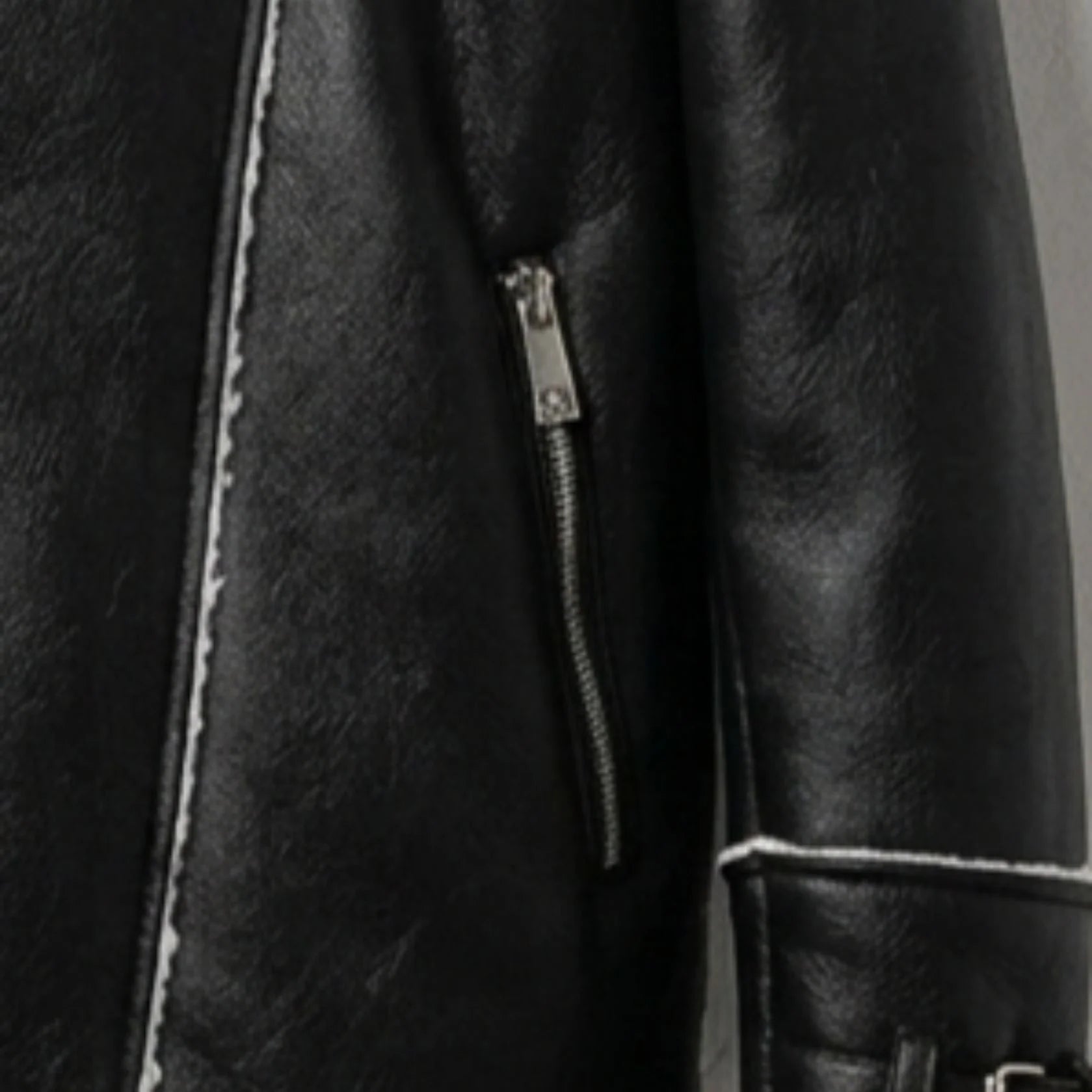 close up zipper pocket on mens black faux leather shearling jacket.