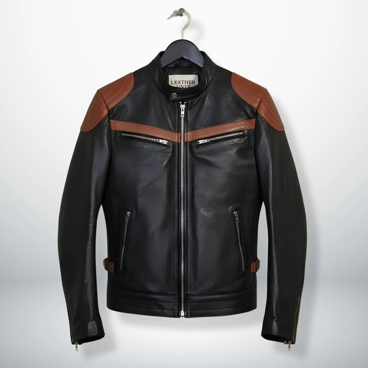 front view of men's black leather biker jacket with brown stripes and zip pockets.