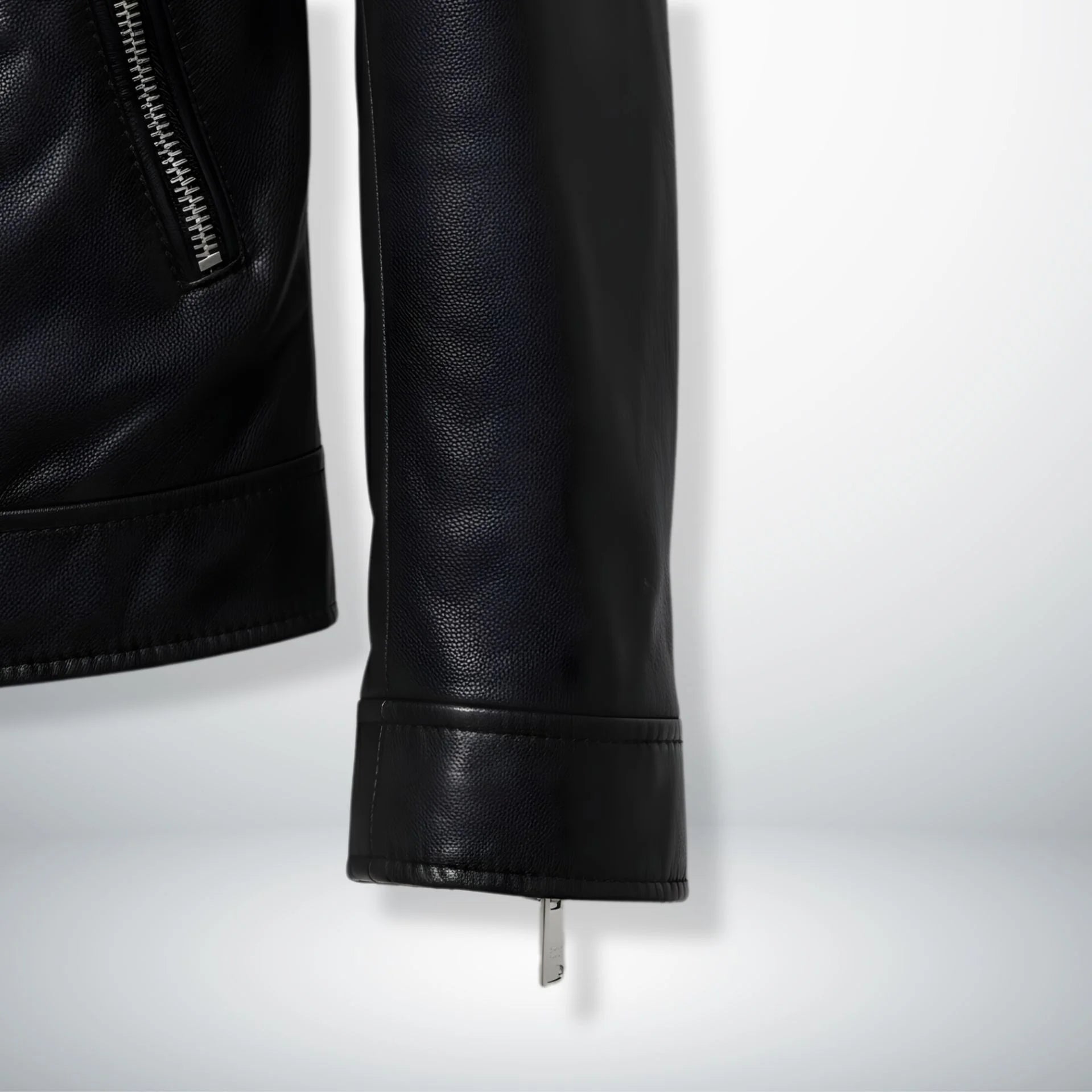 close up of sleeve and cuff zipper on men's black leather biker jacket.
