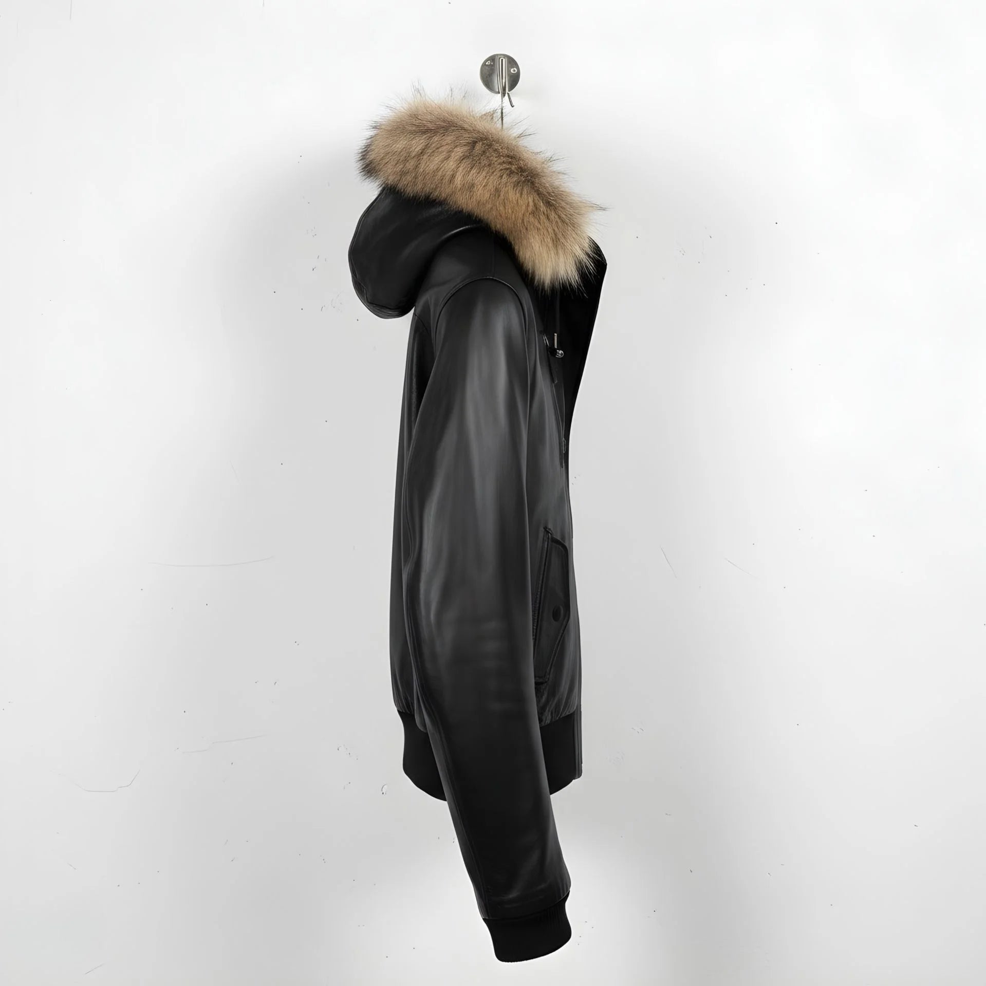side profile of men's black leather jacket with fur trimmed hood.