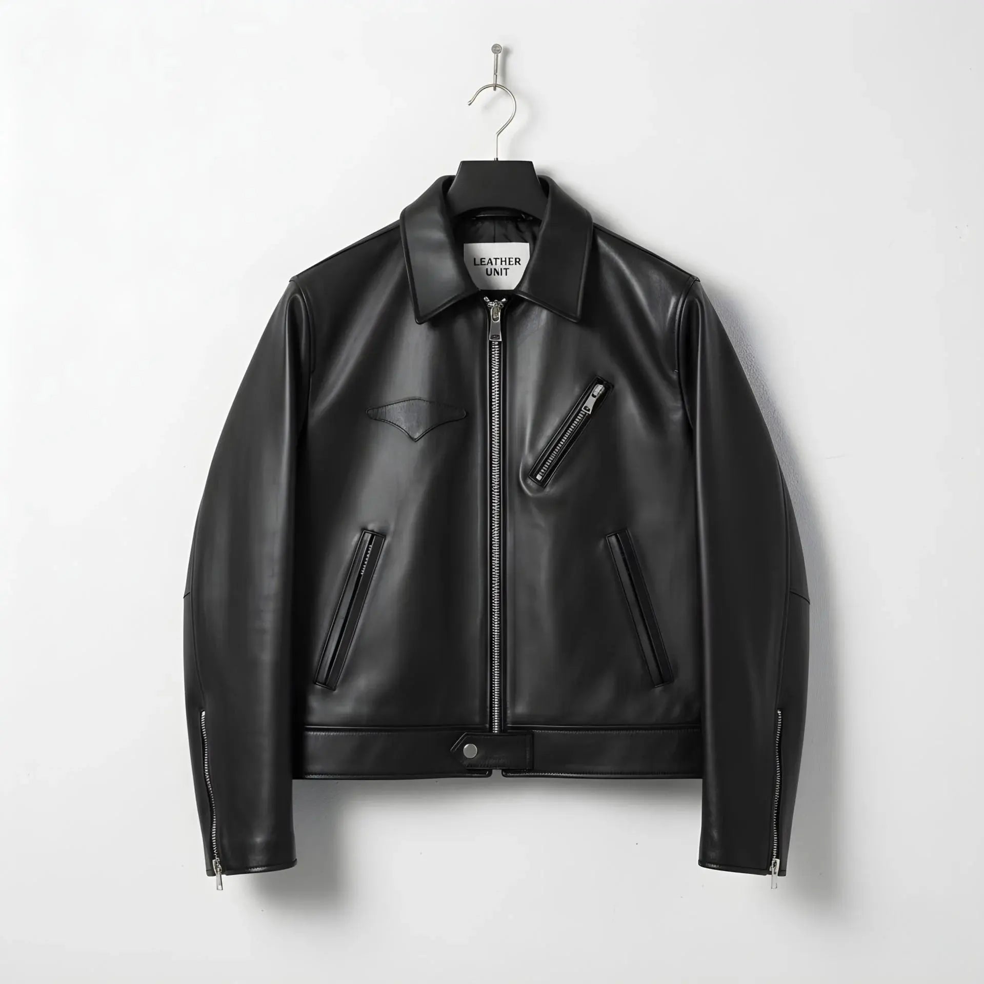 front view of men's black leather jacket with plaid lining and chest zip pocket.