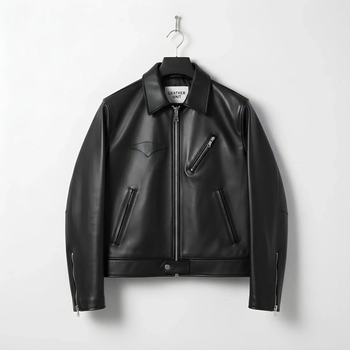 front view of men's black leather jacket with plaid lining and chest zip pocket.