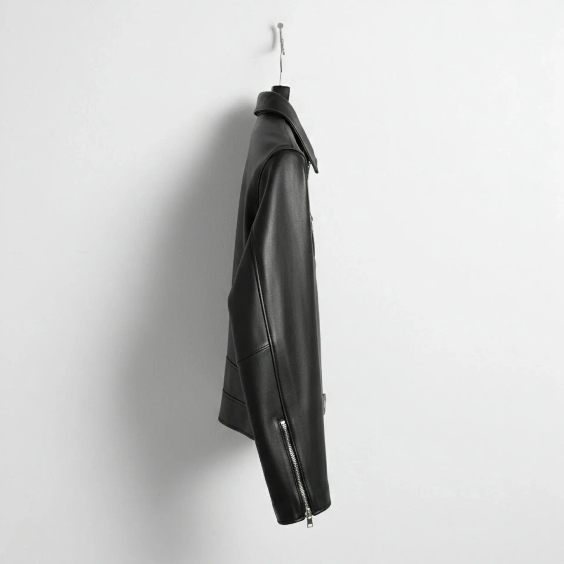 side profile of men's black leather biker jacket with zip cuff detail.