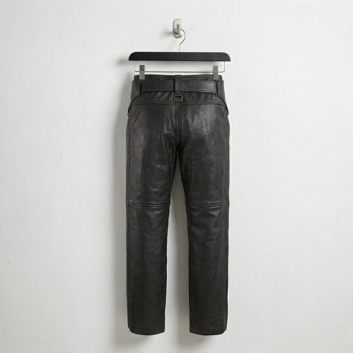 Back view of men's black leather chaps showing straight-leg design