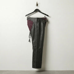 Side profile of men's black leather chaps showing full-length leg coverage