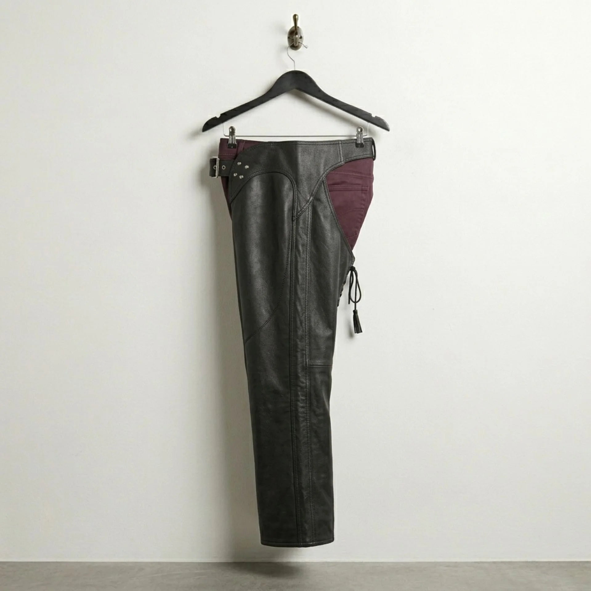 Opposite side profile of black leather motorcycle chaps with curved hip yoke