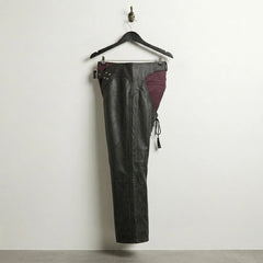 Opposite side profile of black leather motorcycle chaps with curved hip yoke
