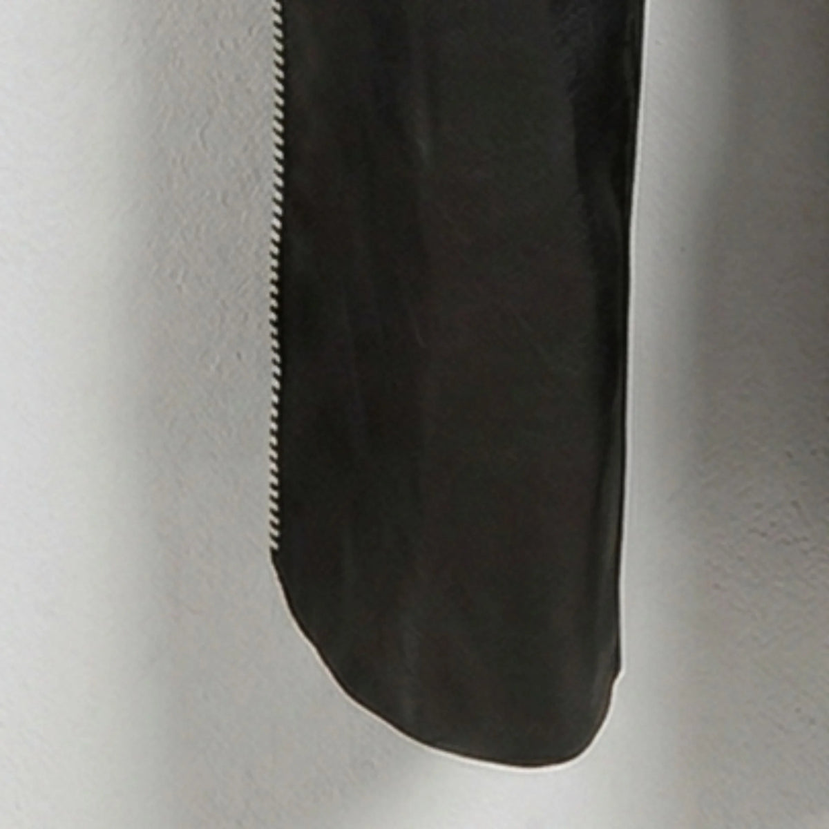 Detail of lower leg and side zipper on genuine black leather chaps