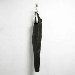 Side profile of men's black leather overalls with slim straight leg