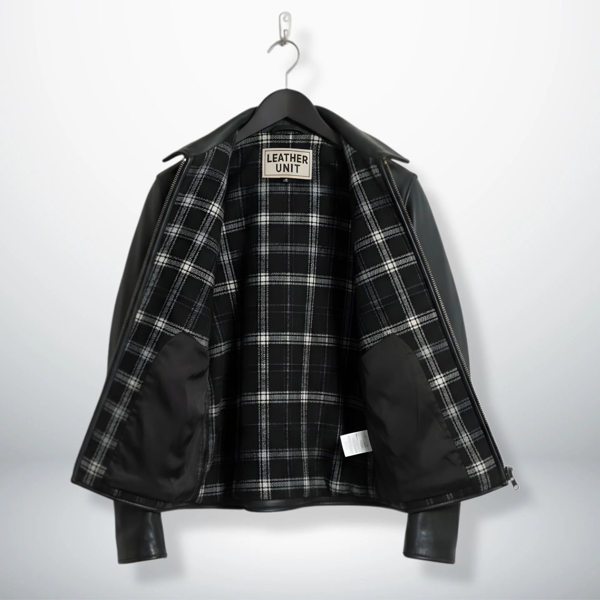 interior of men's black leather rider jacket showing black and white plaid lining.