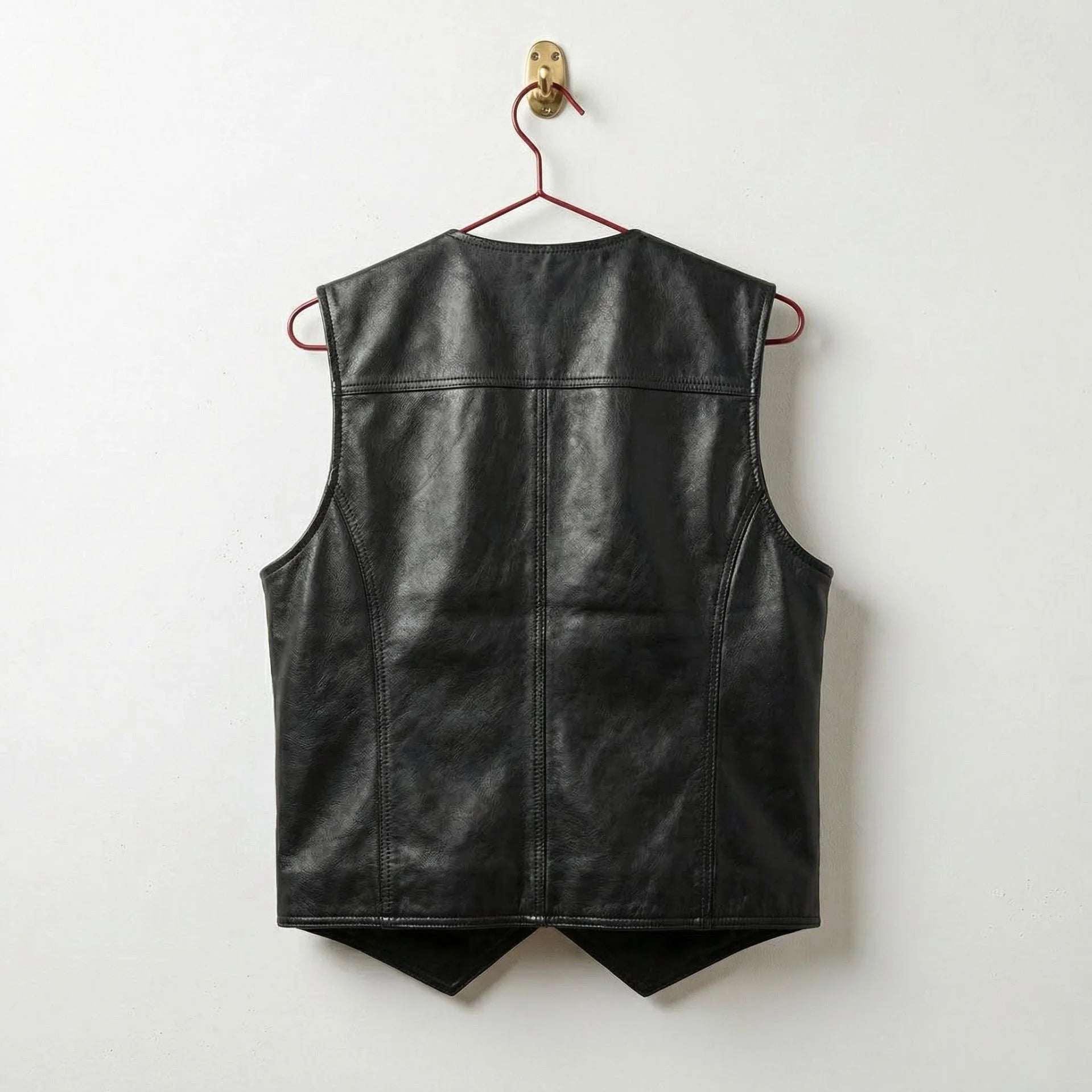 Back of men's black leather western vest showing clean seams and pointed hem
