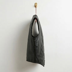 Side profile of men's black leather cowboy vest with tailored fit