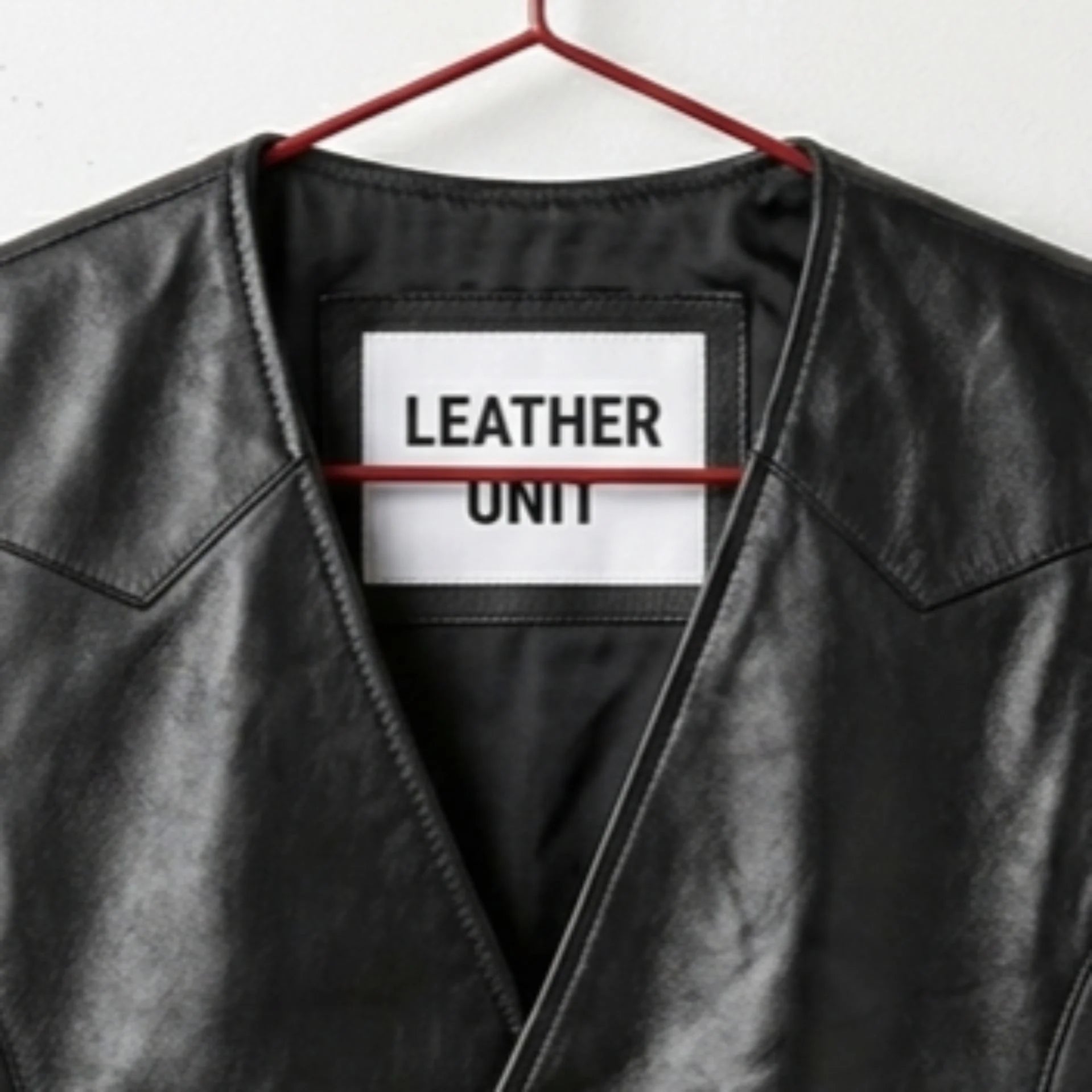 Close-up of V-neck and Leather Unit label on men's black western vest