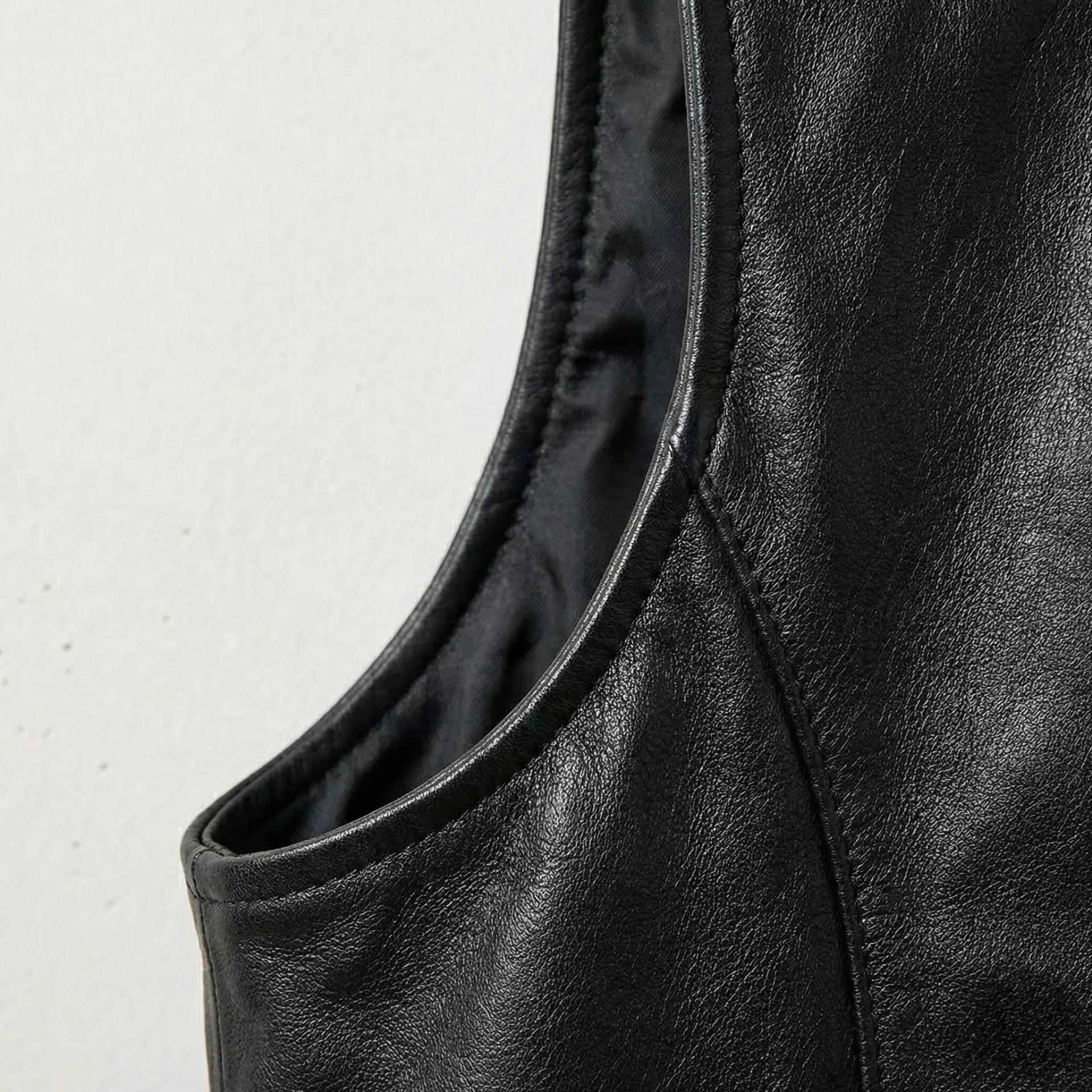 Detail of armhole and stitching on genuine black leather western vest