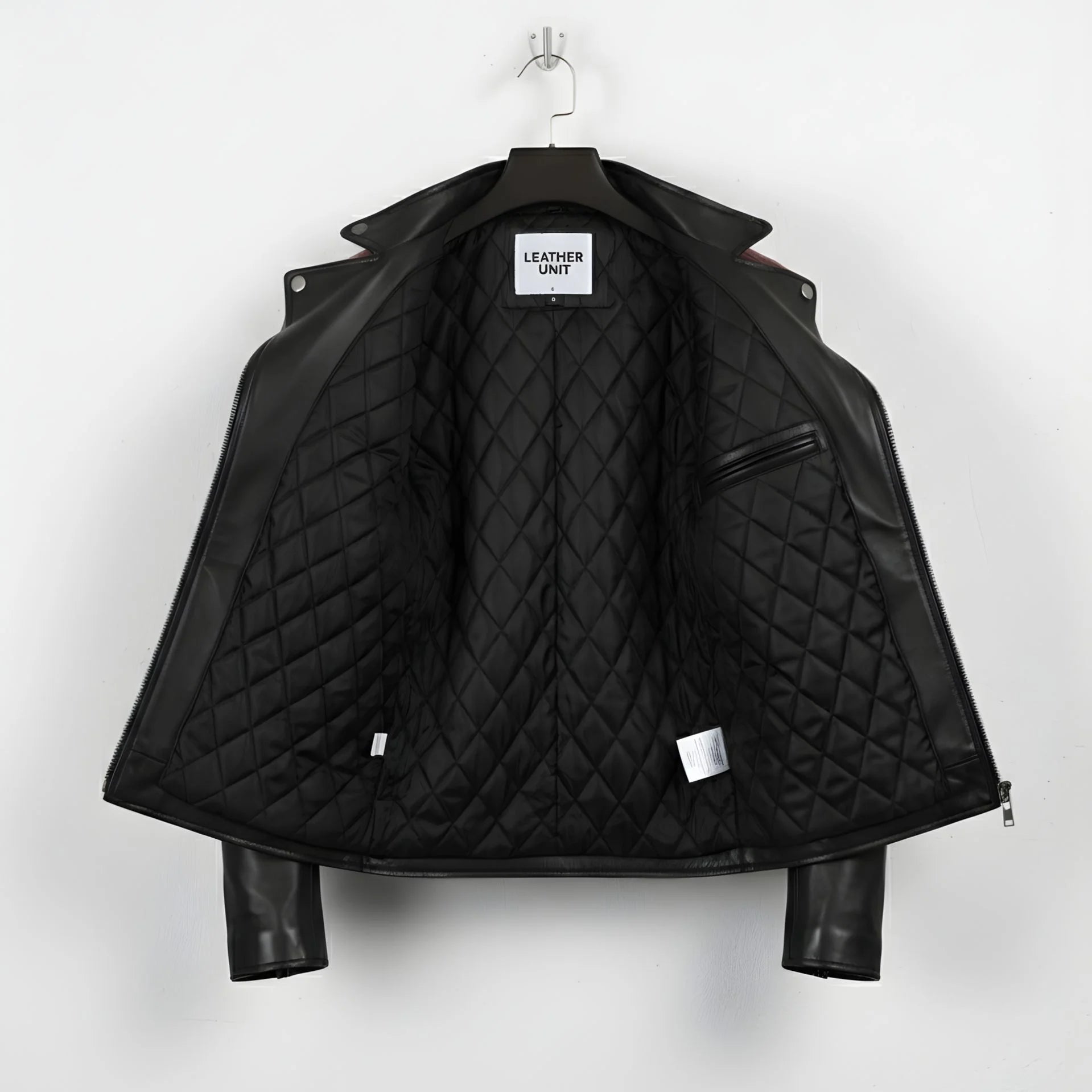 inside view of men's black and maroon biker leather jacket showing quilted lining.