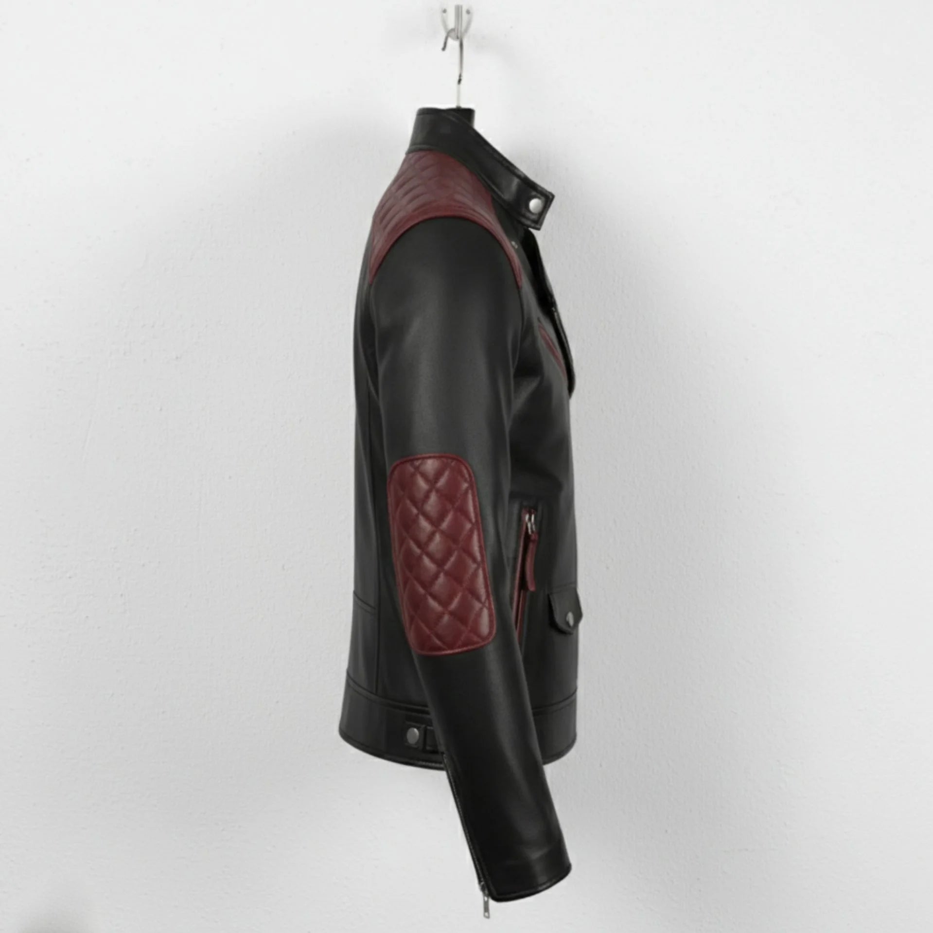 side profile of men's black and maroon leather moto jacket with elbow quilting.
