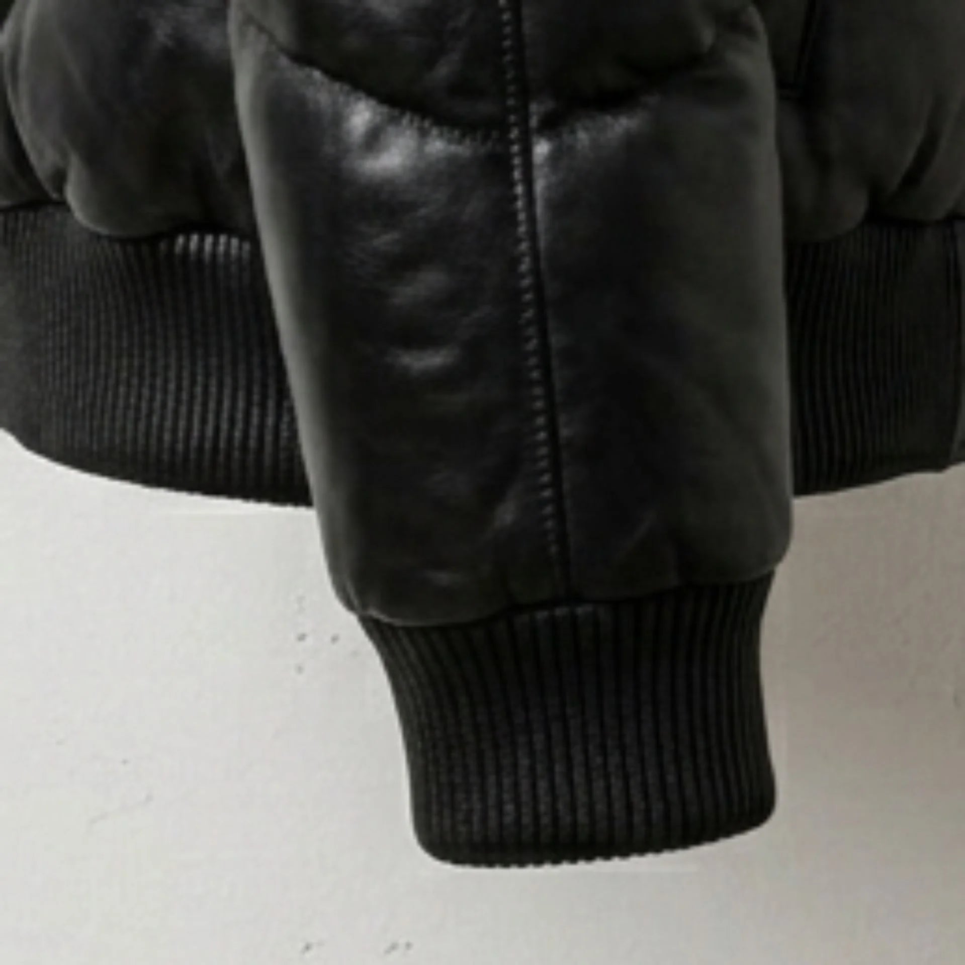 Detailed view of ribbed cuff and premium leather texture