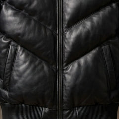 Close-up of functional pockets and heavy-duty zipper on black puffer leather jacket