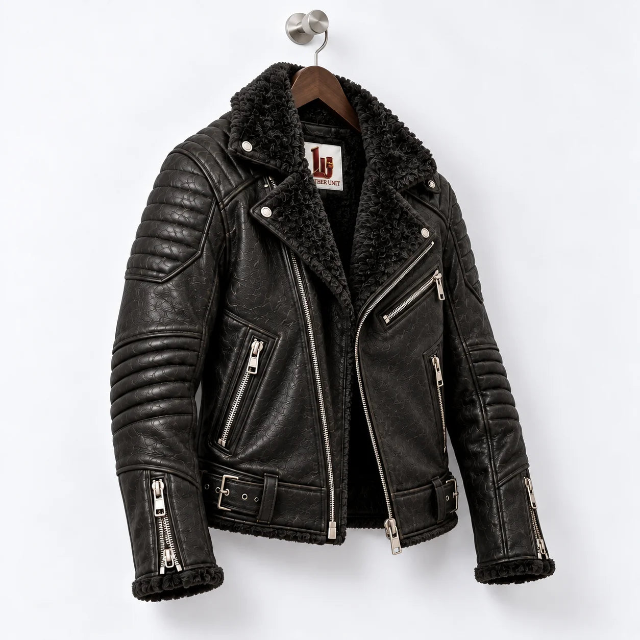 Three-quarter view of obsidian black leather biker jacket with faux fur interior and quilted motorcycle panels