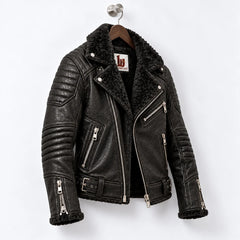 Three-quarter view of obsidian black leather biker jacket with faux fur interior and quilted motorcycle panels
