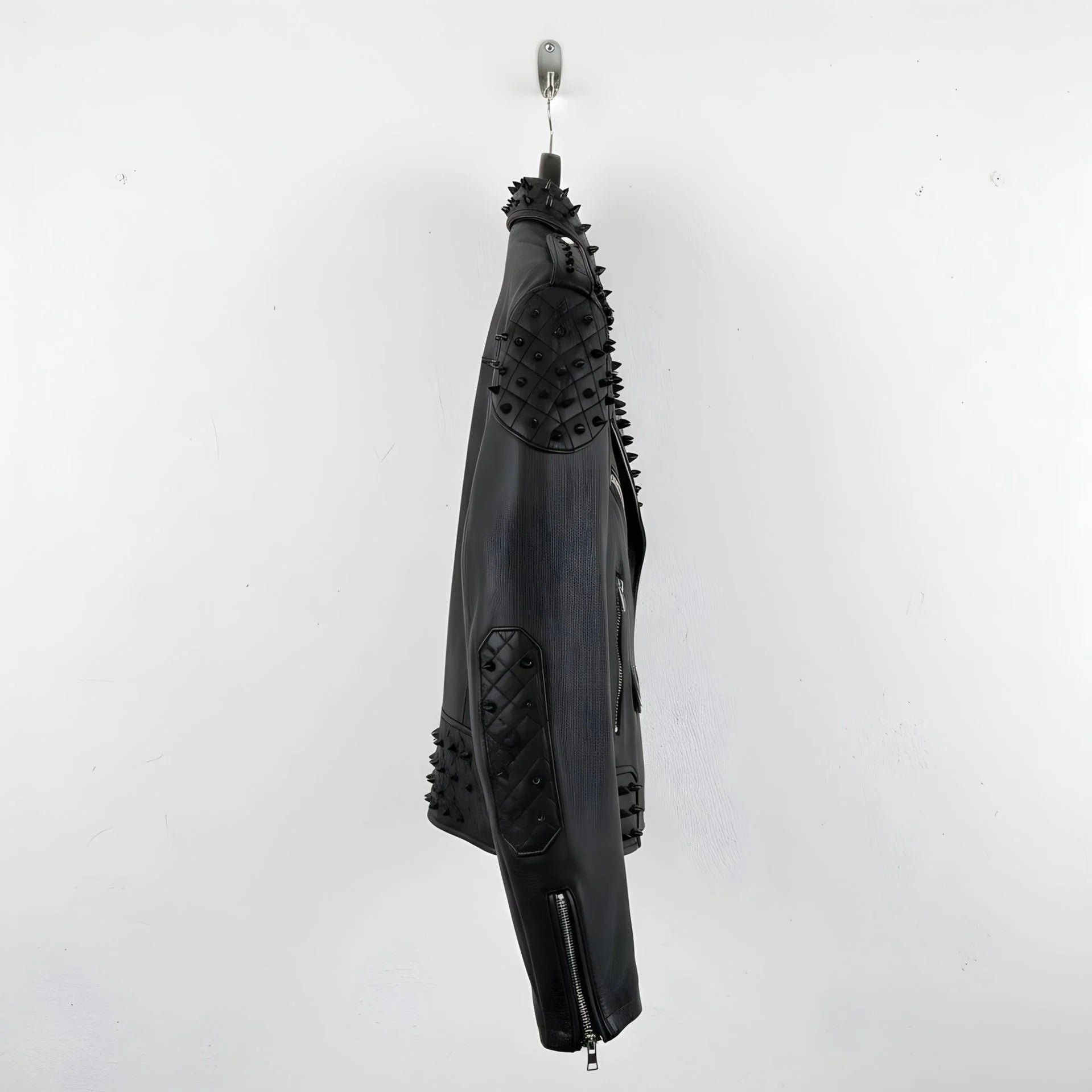 side profile of men's black spike leather jacket with studded elbow panel.