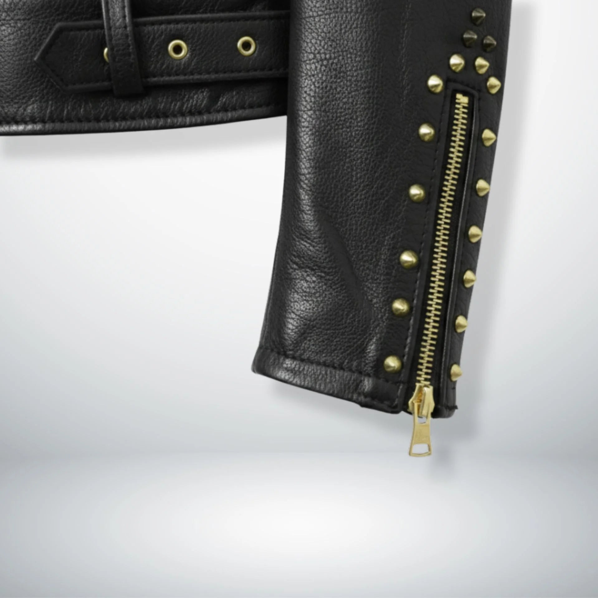 close up of sleeve zipper and studs on men's black spike leather jacket.