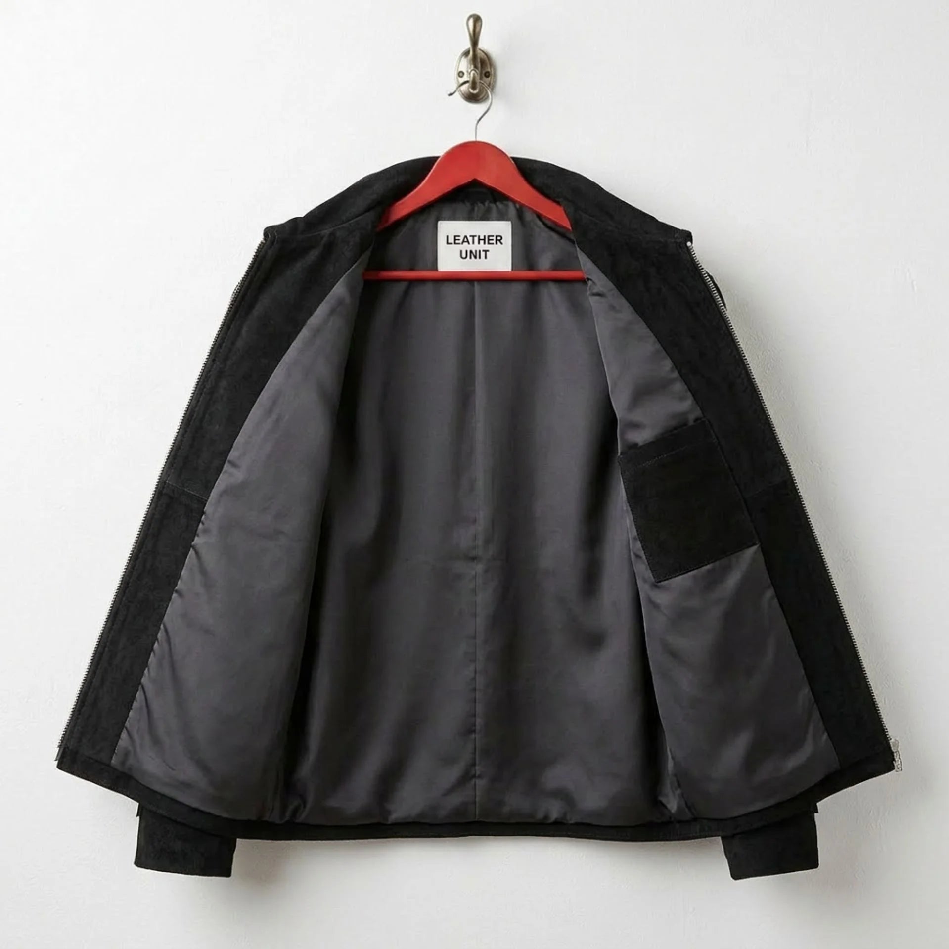 Interior of men's black suede fringe jacket showing grey lining