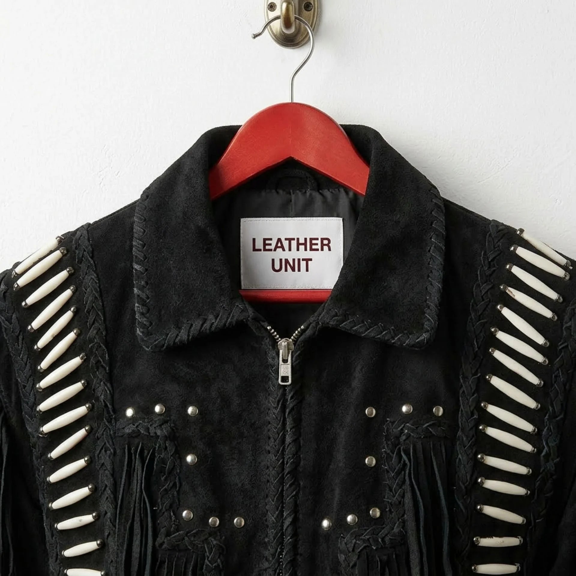 Close up of collar, zipper and Leather Unit label on black suede cowboy jacket.