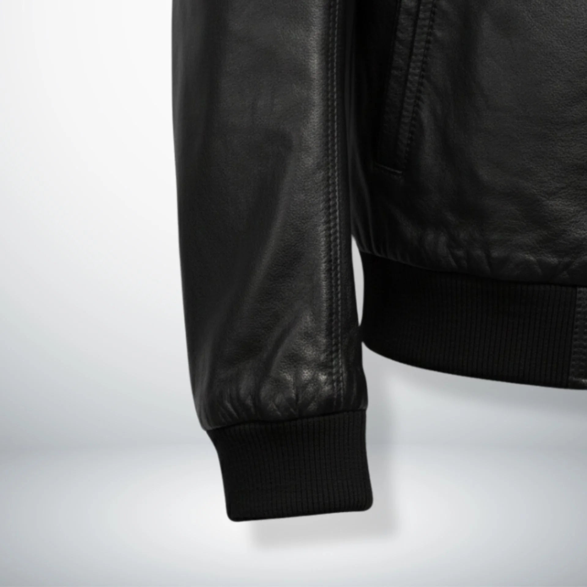 close up ribbed cuff and hem on mens black bomber leather jacket.