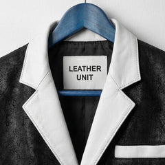 Close up of white notch lapel and Leather Unit label on black leather blazer