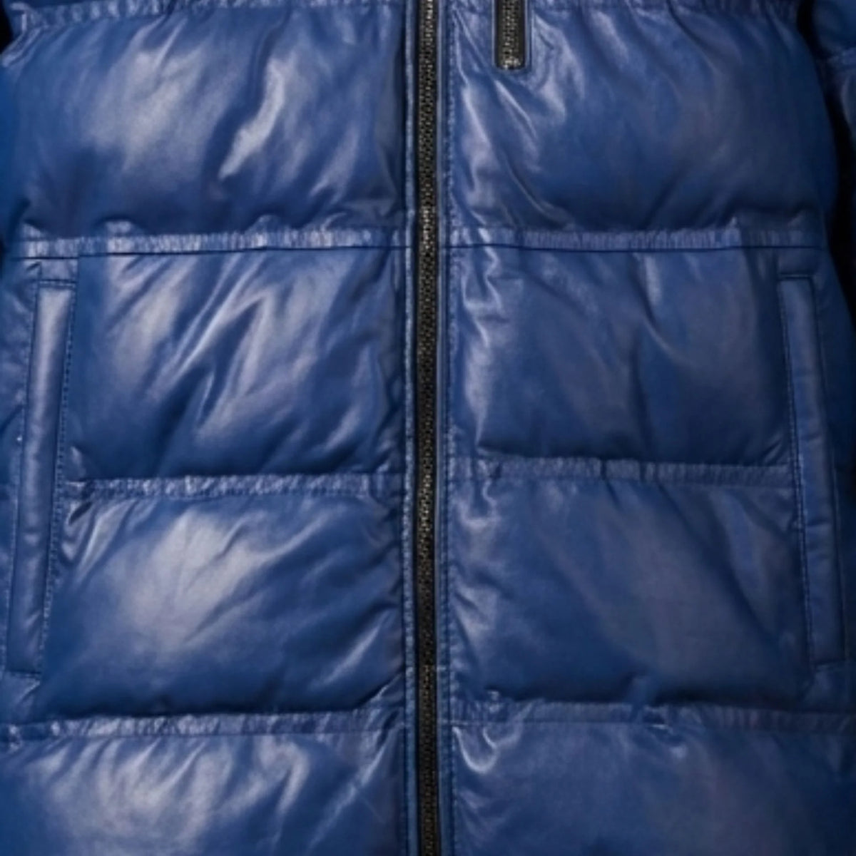 Close up of premium sheepskin leather texture on blue puffer jacket