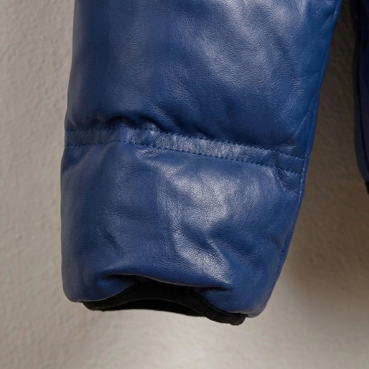 Zippered sleeve pocket on Men's Blue Hooded Leather Puffer Jacket