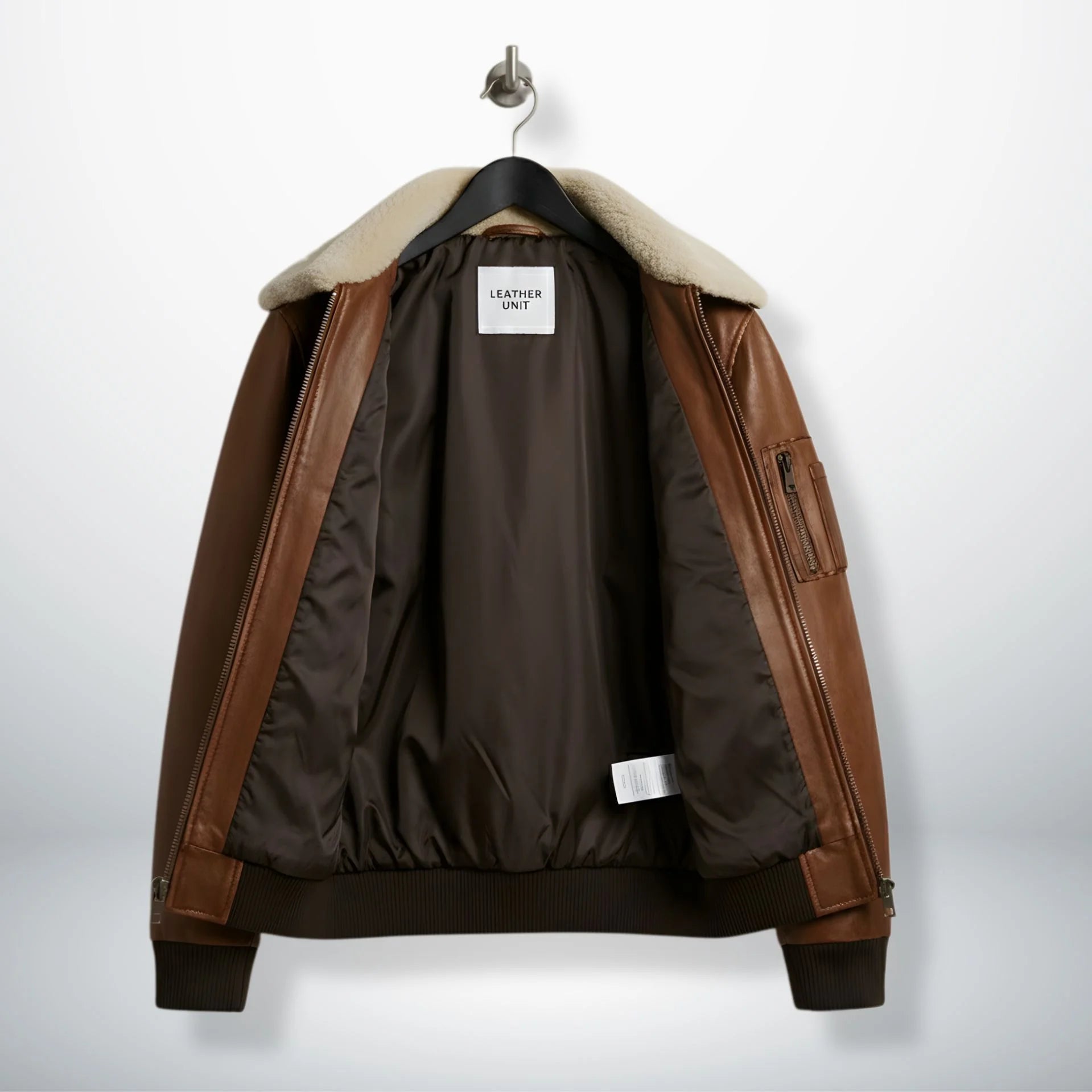 close up of fur style collar and zipper on brown bomber leather jacket.