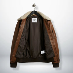 close up of fur style collar and zipper on brown bomber leather jacket.