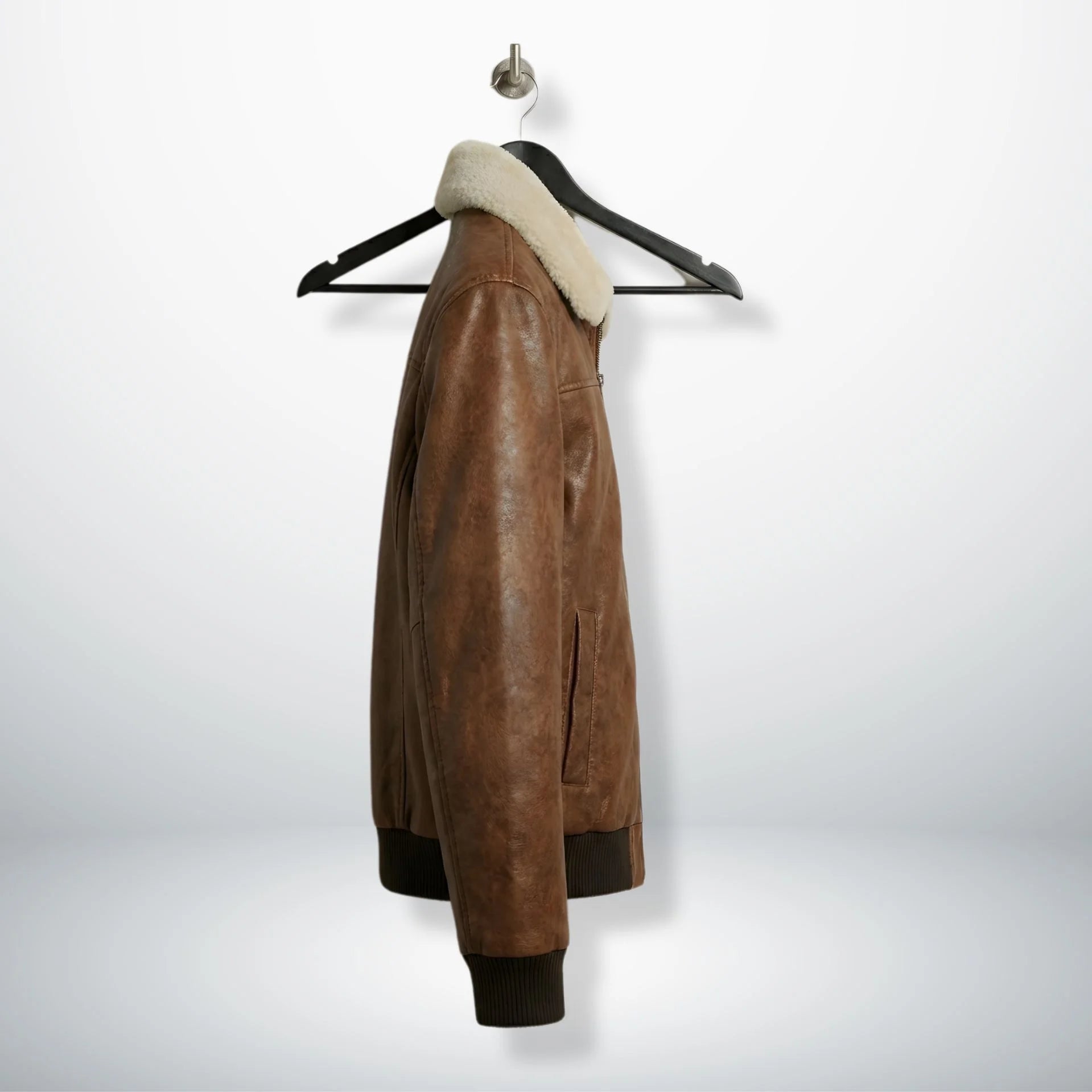 side angle men's brown leather bomber jacket showing pockets.