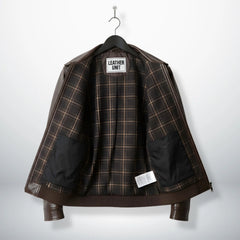inside view brown bomber leather jacket with plaid lining and interior pockets.