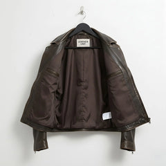 interior view brown cowhide biker jacket showing lining and inner zip pockets.
