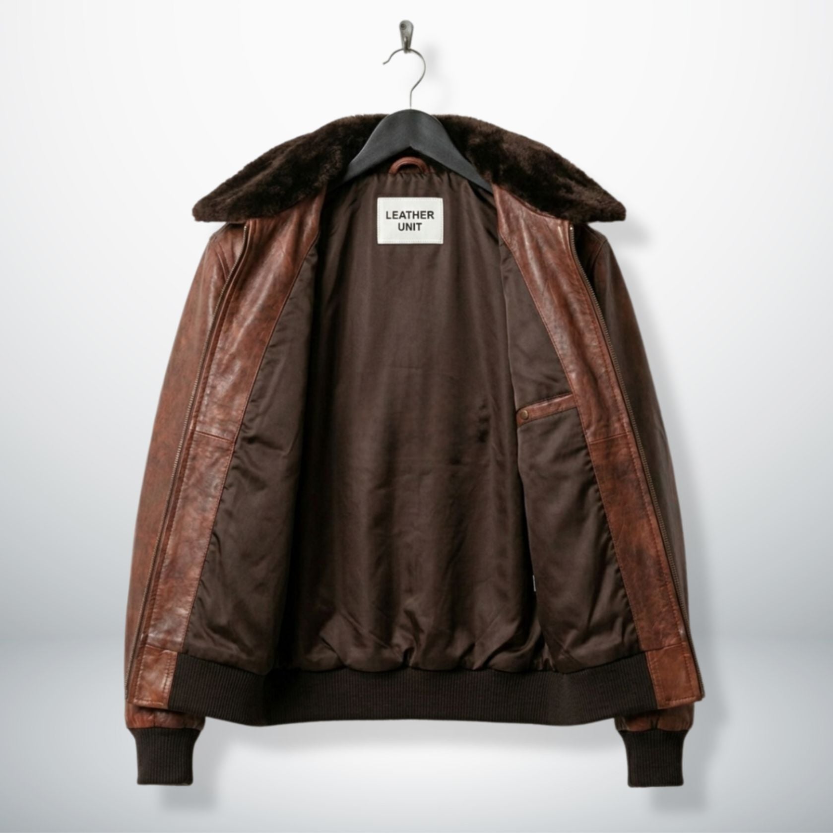 interior view mens brown aviator leather jacket with brown lining and zip pocket.