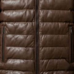 Close-up of vertical zip pockets and heavy-duty zipper on brown leather puffer jacket