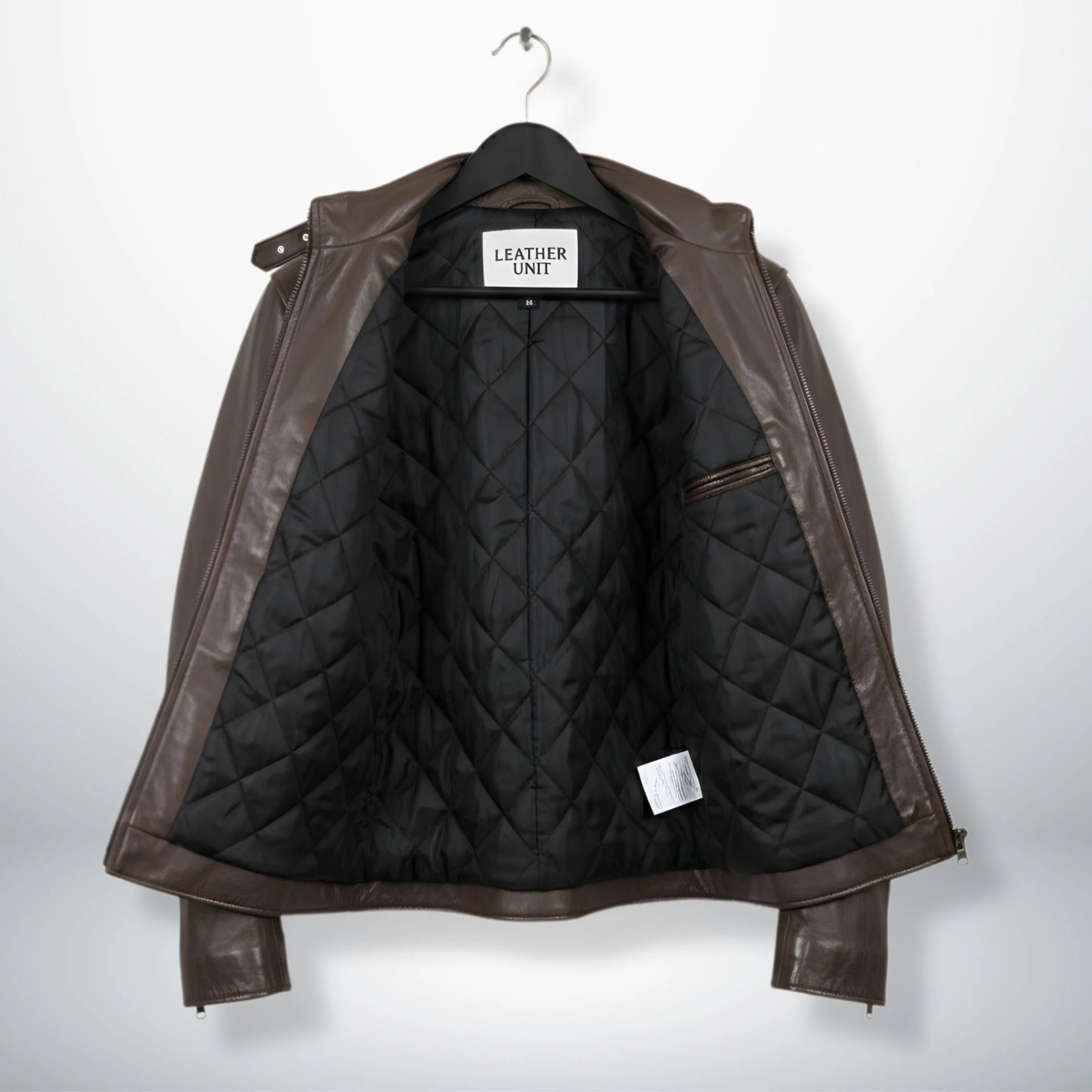 interior of men's brown leather jacket showing black diamond quilted lining.