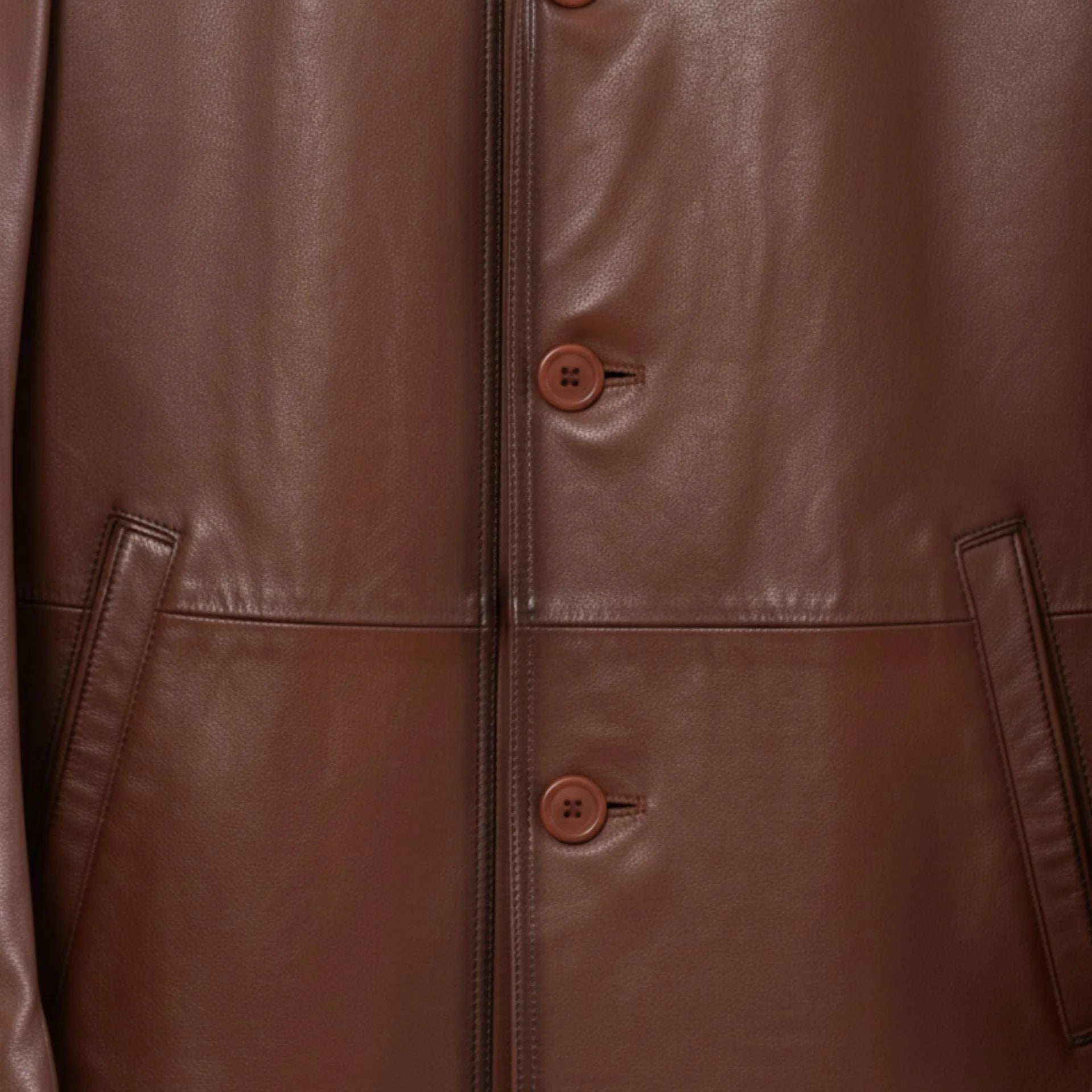 Button front and welt pockets on men’s brown leather blazer jacket